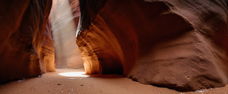 Crimson rock formations and a peaceful atmosphere. This photo captures the timeless beauty of a tight canyon passage in an arid landscape.の素材
