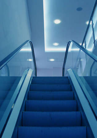 Business center escalator steps in a blue lightの写真素材