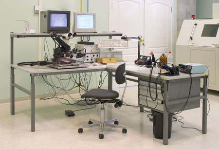 Engineer's work place. Table, microscope and monitor
