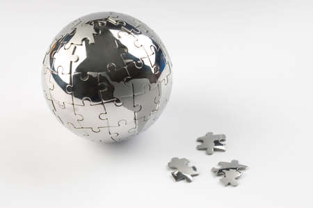 Metaphor image with globe and falling peaces against white backgroundの写真素材