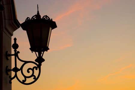 Old street lamp against sky backgroundの写真素材