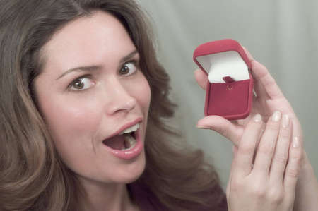 Pretty brunette is very happy to recieve a present in a red box