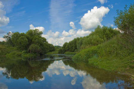 Summer landscape with river trees and the sky
