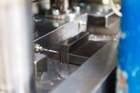 The face milling tool with the raw material work piece on the CNC milling machine.The spindle with holder and tooling for face milling on CNC milling machine. Selective focusの写真素材