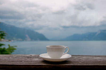 Cup of tea in front of Lake Geneva