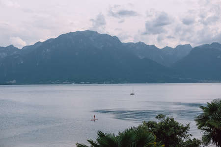 SUP board and small yacht on Lake Genevaの写真素材