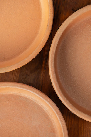 Georgian ketsi top view. Ketsi, traditional handmade unglazed ceramic cookware, clay round frying pan, dish, plate, pot, all in one, close-up, high resolution.の写真素材