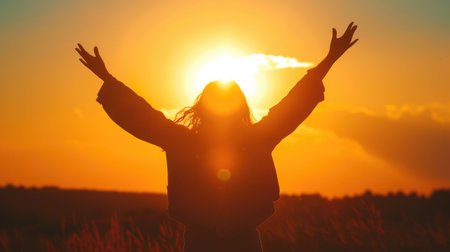 Woman Embracing the Sunset with Open Armsの素材