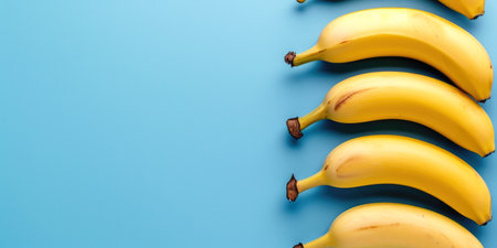Freshness in Simplicity: Bunch of Bananas on Bright Blue Backgroundの素材