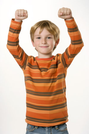 Happy Boy with Arms Raised in Striped Orange Shirtの素材