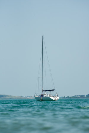 Sailing yacht in the sea on a background of blue sky.の写真素材