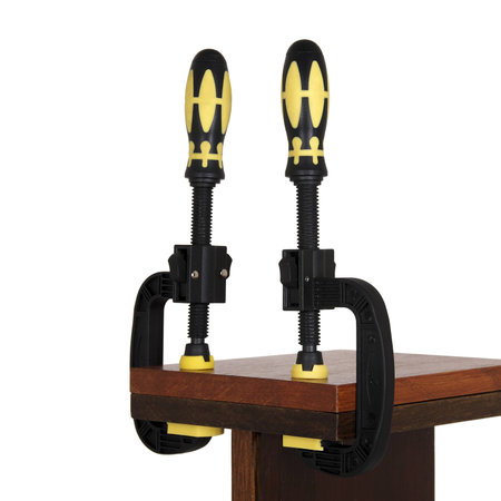 clamps of yellow color hold two wooden bars on a white background. Use F-clamp to holding or catch wood in woodworking.の写真素材