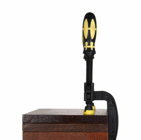 clamps of yellow color hold three wooden bars on a white background. Use F-clamp to holding or catch wood in woodworking.の写真素材
