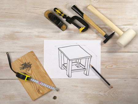 sketch furniture on a white sheet of paper, the top view on wooden table with toolsの写真素材