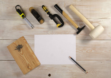 a white sheet of paper and a pencil to sketch, the top view on wooden table with toolsの写真素材