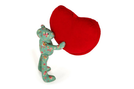 Green Teddy bear holds in paws big red heartの写真素材
