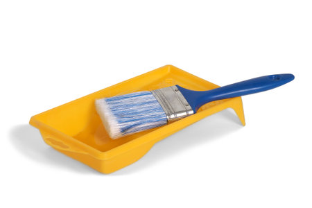 pure blue brush in the orange paint tray , isolatedの写真素材