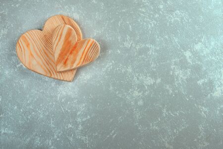 couple of wooden hearts on an abstract background. Valentine's day background. wedding hearts.の写真素材
