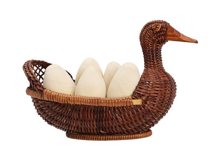 Happy Easter. eggs in a wicker basket isolated. duck wicker. wooden egg. handmade artisan.の写真素材