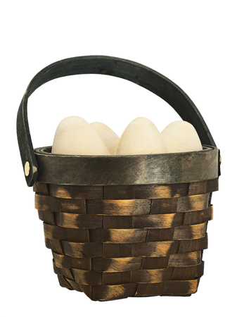 Happy Easter. eggs in a wicker basket isolated. duck wicker. wooden egg. handmade artisan.の写真素材