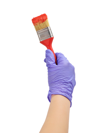 hand paints the heart with a brush
hand paint in red wooden heart
hand in blue glove holds a red brushの写真素材