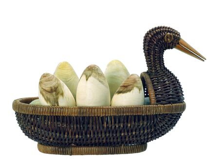 Happy Easter. eggs in a wicker basket isolated. duck wicker. wooden egg. handmade artisan. の写真素材