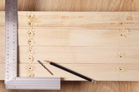 draw a layout of the wood. pencil and set square for accurate marking of the holes.の写真素材