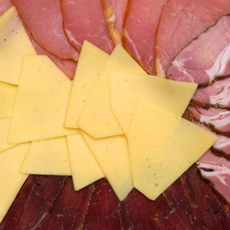 background of sliced cheese and meatの写真素材