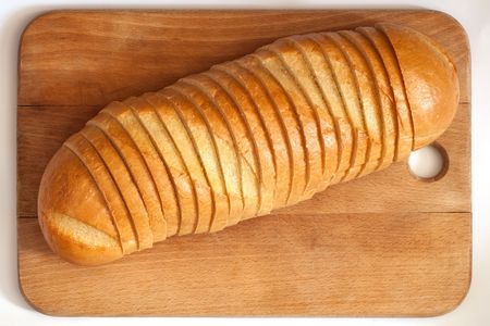 cutting bread on a boardの写真素材