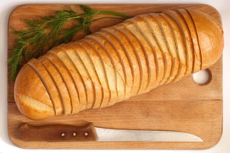 knife and cutting bread on a boardの写真素材