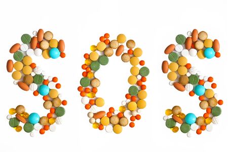 word sos made of pills isolated on whiteの写真素材