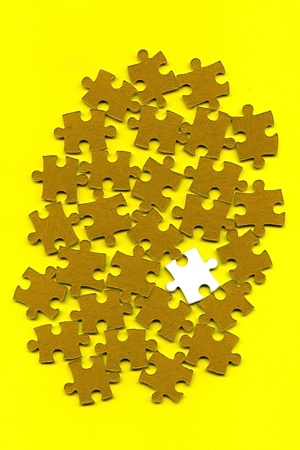 puzzle pieces on a yellow backgroundの写真素材