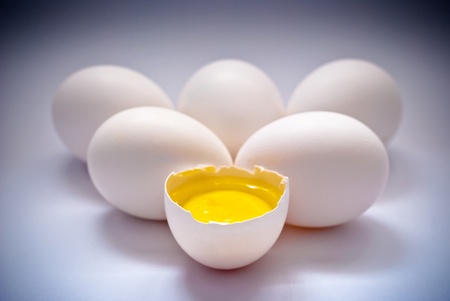 eggs with yolk on a blue backgroundの写真素材