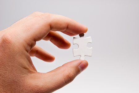 hand holding single puzzle piece