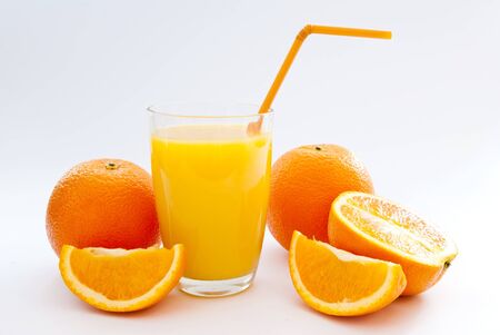 a cup of orange juice and fresh orangeの写真素材