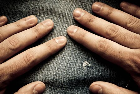 background made of blue jeans with handsの写真素材