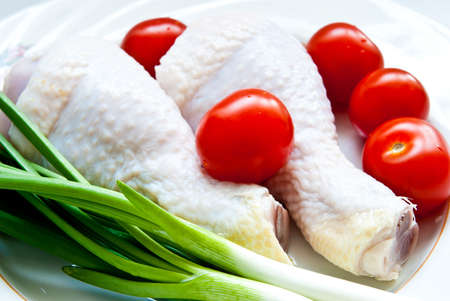 raw chicken with vegetables as a backgroundの写真素材