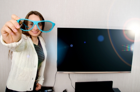 woman in 3d glasses with tv indoors