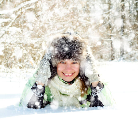 happy young woman in winter outdoorsの写真素材