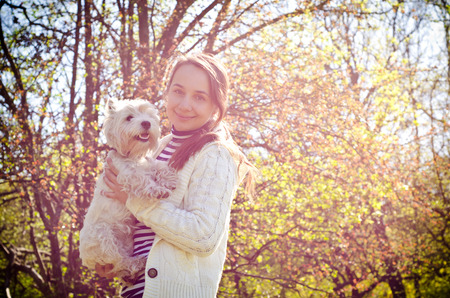woman with dog in the parkの写真素材