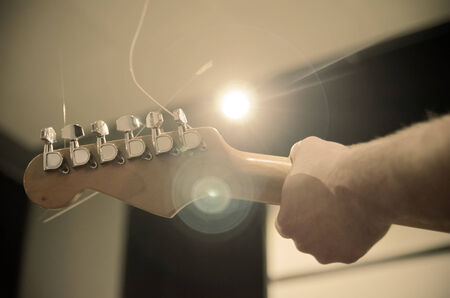 musician playing a guitar in studio