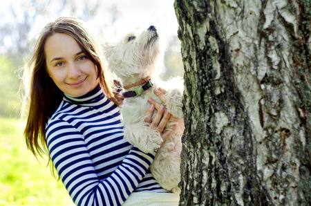 woman with west highland terrierの写真素材