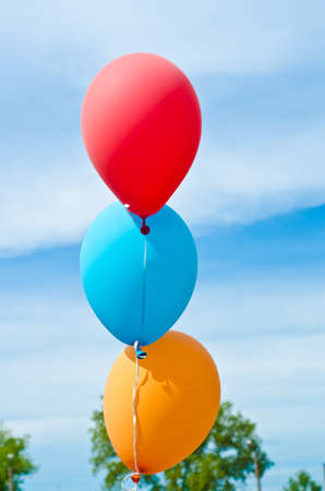 three balloons flying in the skyの写真素材