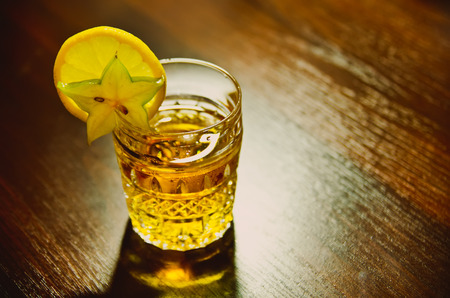 a cup of whiskey with lemonの写真素材