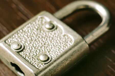 old padlock on a wooden backgroundの写真素材