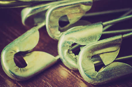 a lot of pinheads on a wooden backgroundの写真素材