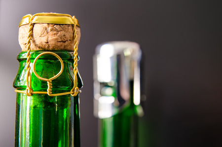 green champagne bottle with cork closeup