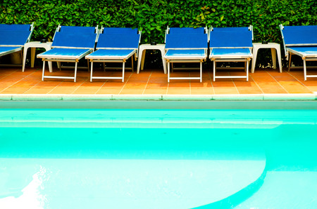 pool with chaise-longues in hotel