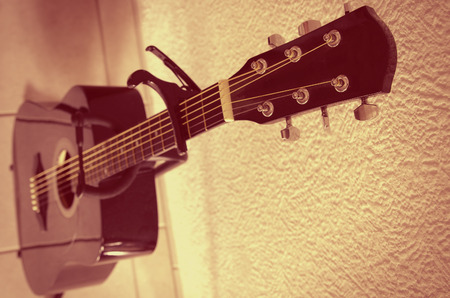 acoustic guitar with capo on a fingerboardの写真素材