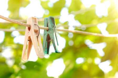 old clothespins on the rope outdoorsの写真素材